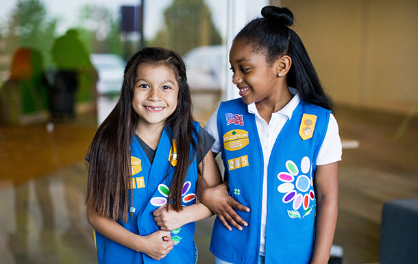 two girl scouts standing together
