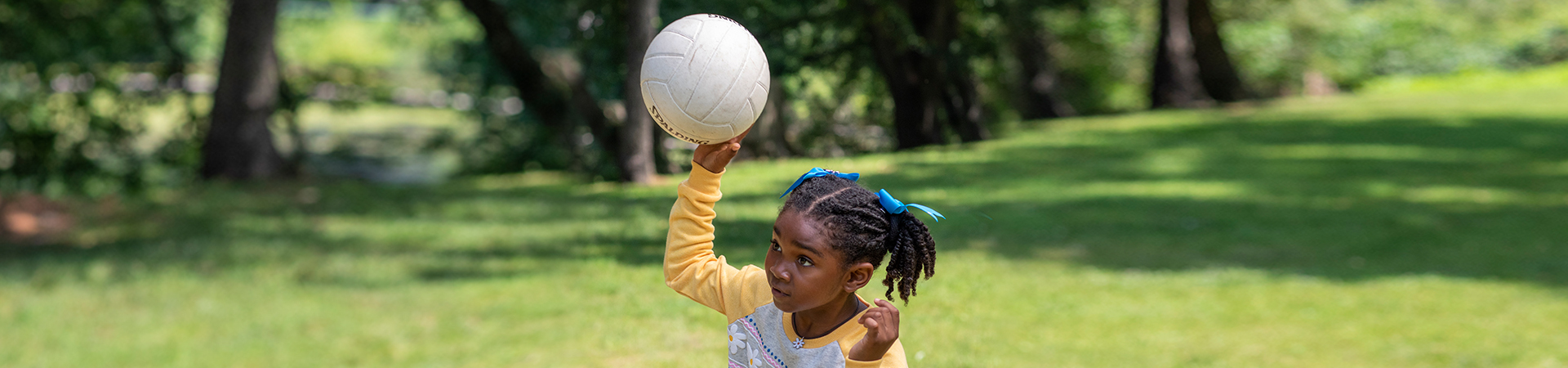  girl with soccer ball playing outside 
