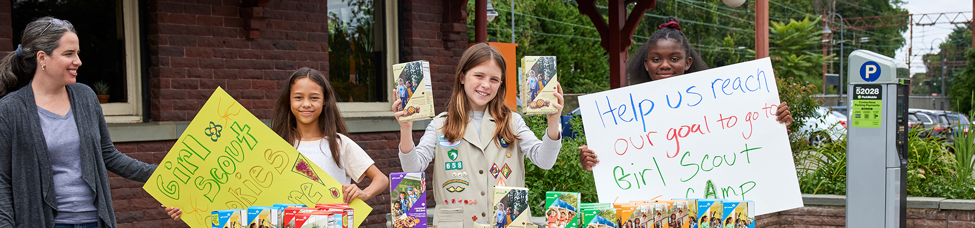  girl scouts at cookie booth 